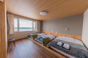 
a bed room with two beds and a window at Hotel Kifu Club Shiretoko in Shari

