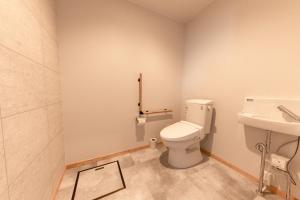 
a bathroom with a toilet and a sink at Hotel Kifu Club Shiretoko in Shari
