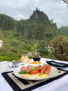 a plate of food with eggs sausage and vegetables on a table at Manuel Manor in Labugolla