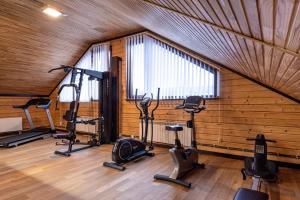 a gym with several exercise bikes in a room at Chalet du Mont in Bukovel