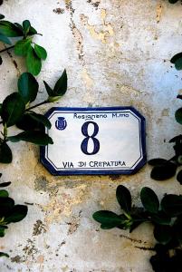 a blue and white sign on a wall at Hotel Signorini in Castiglioncello