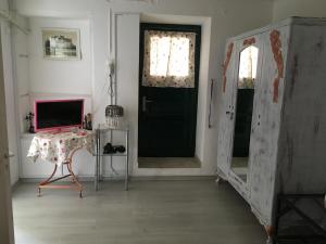 a living room with a black door and a table at Toula's house 2 in Spetses