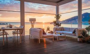 a living room with a view of the water at Dukley Hotel & Resort in Budva