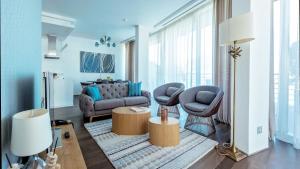 a living room with a couch and two chairs at Dukley Hotel & Resort in Budva