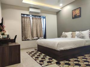 Un pat sau paturi într-o cameră la Visawa Palace Nanded