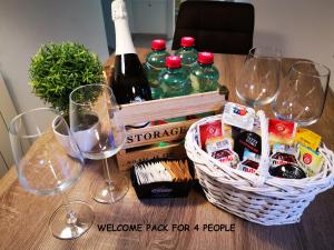 a table with wine glasses and a basket with wine bottles at Casa Da Ponte in Koper