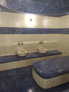 a bathroom with two sinks and two toilets at KavKaz Hotel & Restaurant in Marneuli