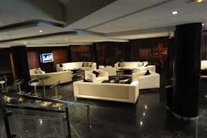 a lobby with white couches and tables at Rive Hotel in Rabat