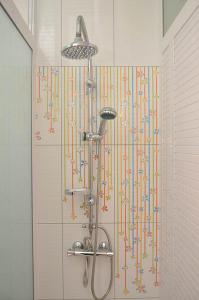 a shower with colorful streamers on the wall in a bathroom at Residence Coin De Mire in Bain Boeuf