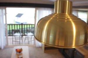 a large gold lamp in a living room with a porch at The Royal Clovelly caravan with sea views in Bideford