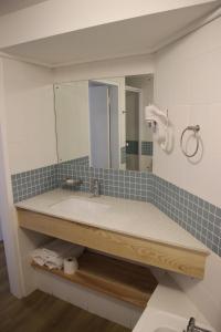 y baño con lavabo y espejo. en The Boardwalk Accommodation en Gordonʼs Bay