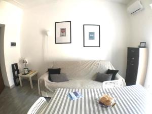 a bedroom with a bed and a table and chairs at White Sand Alghero in Alghero