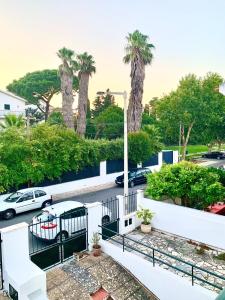 a view from a balcony of a parking lot with palm trees at Cascais Spacious Getaway in Cascais