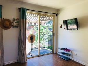 a room with a sliding glass door to a balcony at Charlie sweet home at Mornington Peninsula in Mount Martha