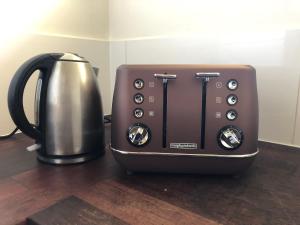 a toaster sitting next to a coffee maker at Charlie sweet home at Mornington Peninsula in Mount Martha
