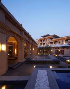 - un bâtiment avec piscine la nuit dans l'établissement Wyndham Grand Tianjin Jingjin City, à Tianjin