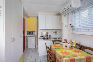 a kitchen and a table with a table cloth on it at Camping Village Miramare in Cavallino-Treporti
