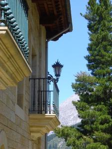 a balcony with a light on a building with a tree at Haras Aritza in Ojedo