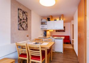 a kitchen and dining room with a table and chairs at Haus Aktiv in Obergurgl