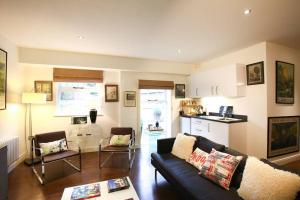 a living room with a couch and a kitchen at Old Croft Stables in Quarndon