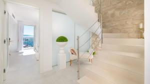 a white staircase in a home with a stone wall at Villa Marina Hvar in Hvar +28 photos