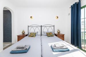 a bedroom with a large bed with blue curtains at EL ZAFIRO in Puerto del Carmen