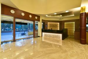 a lobby with a reception desk in a building at Panchavati Elite Inn in Nashik