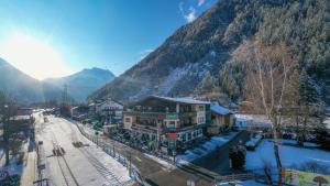 a town in the mountains with snow on the ground at Hotel Landhaus Carla in Mayrhofen