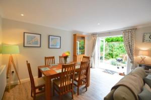 a kitchen and dining room with a table and a couch at September Sea in Port Isaac