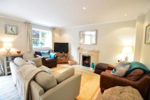 a living room with a couch and a fireplace at September Sea in Port Isaac