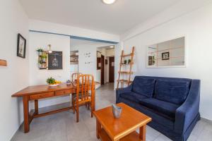 a living room with a blue couch and a table at A32 - Postigo Apartment in Lagos in Lagos