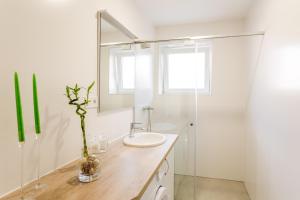 a bathroom with a sink and a mirror at FLEXIHOME SK - Komenskeho - private parking spot - ultra modern and stylish in Košice