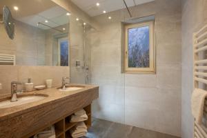 a bathroom with two sinks and a large mirror at Landgasthof Jagerwirt in Volders