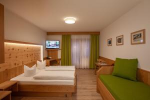 a hotel room with two beds and a tv at Landgasthof Jagerwirt in Volders