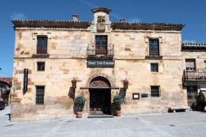 a large stone building with a door in front at Hotel Tres Coronas de Silos in Santo Domingo de Silos