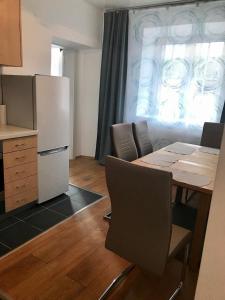 a kitchen with a table and chairs and a refrigerator at Apartment Jasmine in Passail