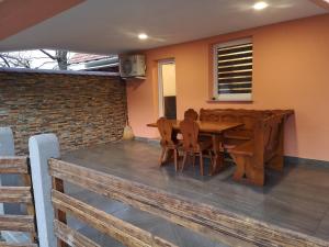 a wooden table and chairs on a patio at APP Aleksa 6168 in Čatež ob Savi