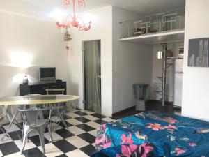 a living room with a table and a dining room at Maison Julien 3 in Menton
