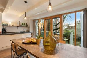 a kitchen with a table with a vase on it at Lovely Jordaan Home in Amsterdam
