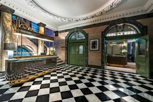 a lobby with a checkered floor and green doors at Stock Exchange Hotel in Manchester