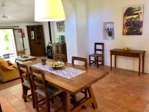 a living room with a wooden table and chairs at Finca Can Trui in Pollença