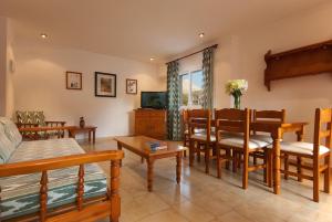 a living room with a table and a dining room at PINOS ALTOS 16 in Cala de Sant Vicenc