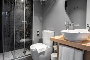 a bathroom with a toilet, sink, and bathtub at Stay Hotel Lisboa Centro Chiado in Lisbon