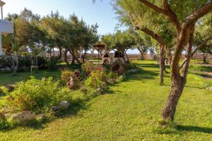 a garden with trees and flowers in a yard at Zefyros Apartments and House in Kissamos