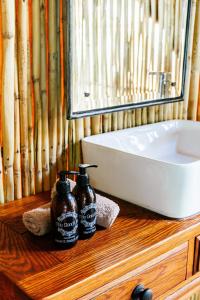 a bathroom with a sink and a bottle of soap at Cradlestone Camp in Krugersdorp