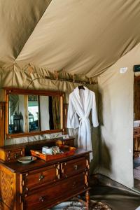 a dressing room with a dresser and a mirror at Cradlestone Camp in Krugersdorp +57 photos