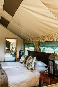 a bedroom with a bed in a tent at Sibani Lodge - Glamping Tents in Krugersdorp