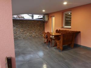 a dining room with a wooden table and chairs at APP Aleksa 6168 in Čatež ob Savi +18 photos