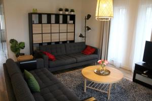 a living room with a couch and a table at Polderhoek in Woubrugge