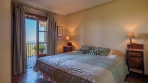 a bedroom with a large bed and a balcony at Casa Bonaire Esporles in Esporles +46 photos